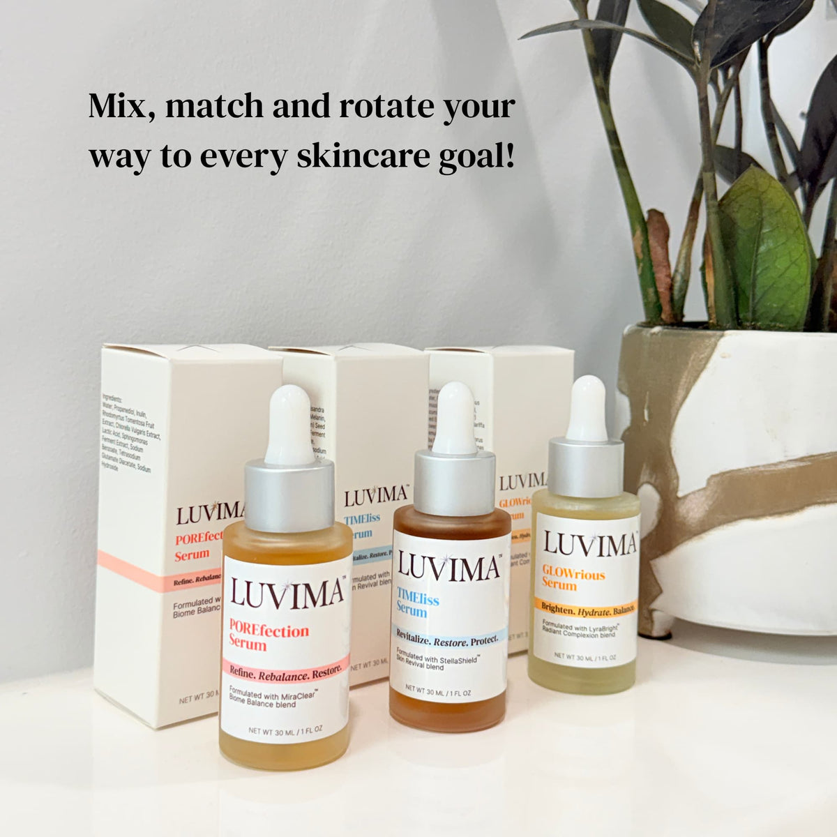 LUVIMA serum bottles and cartons displayed beside a potted plant, featuring POREfection, TIMEless, and GLOWrious Serums.