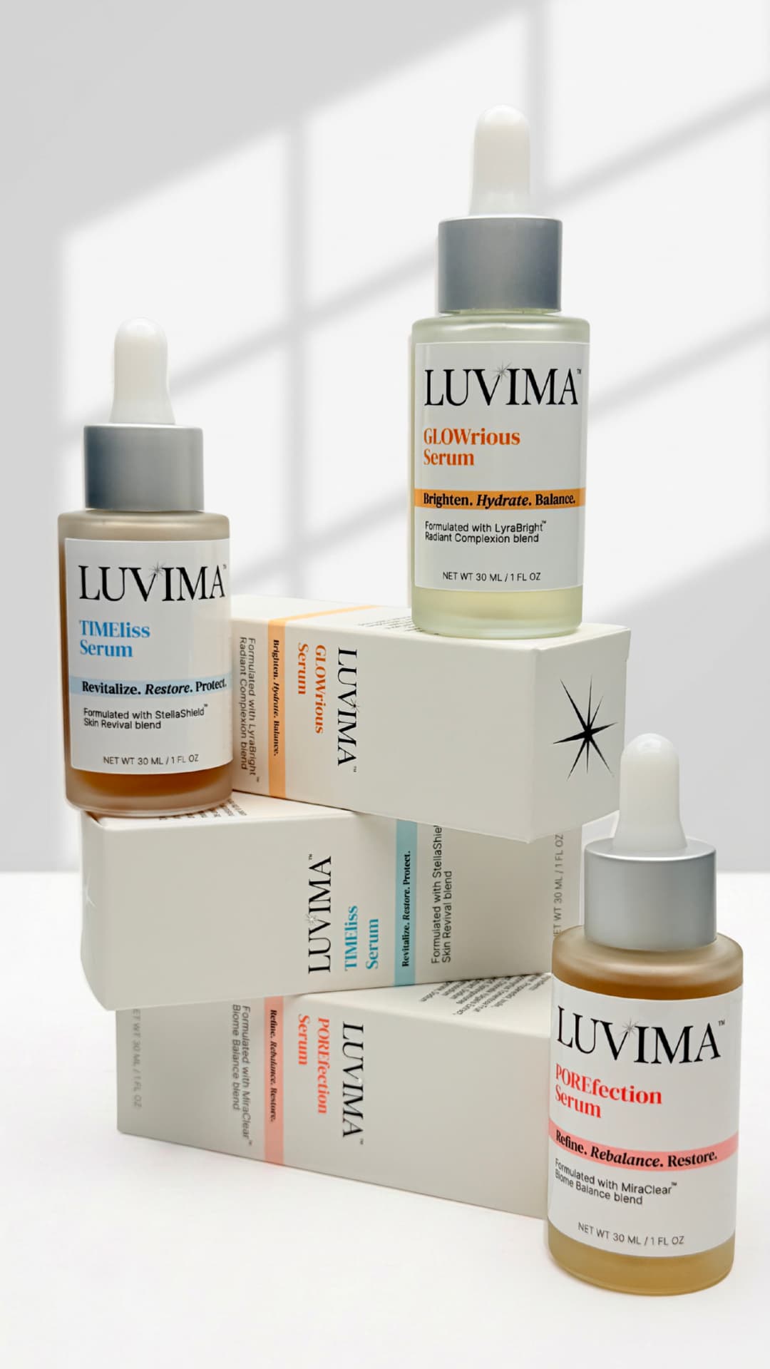 LUVIMA serum bottles stacked on top of packaging boxes on a white background